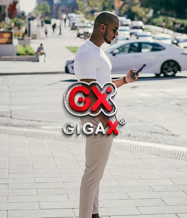 Man using phone outdoors to login into GigaXeSIM account, staying connected while traveling.