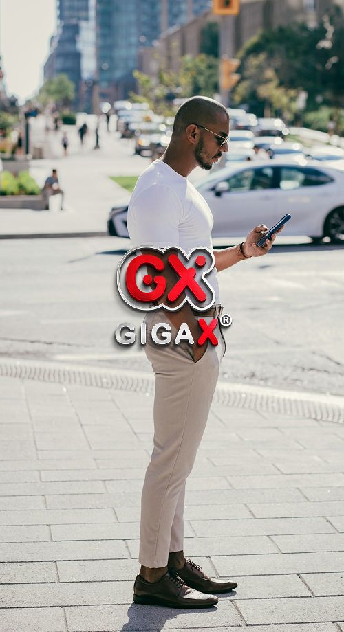 Man using phone outdoors to login into GigaXeSIM account, staying connected while traveling.